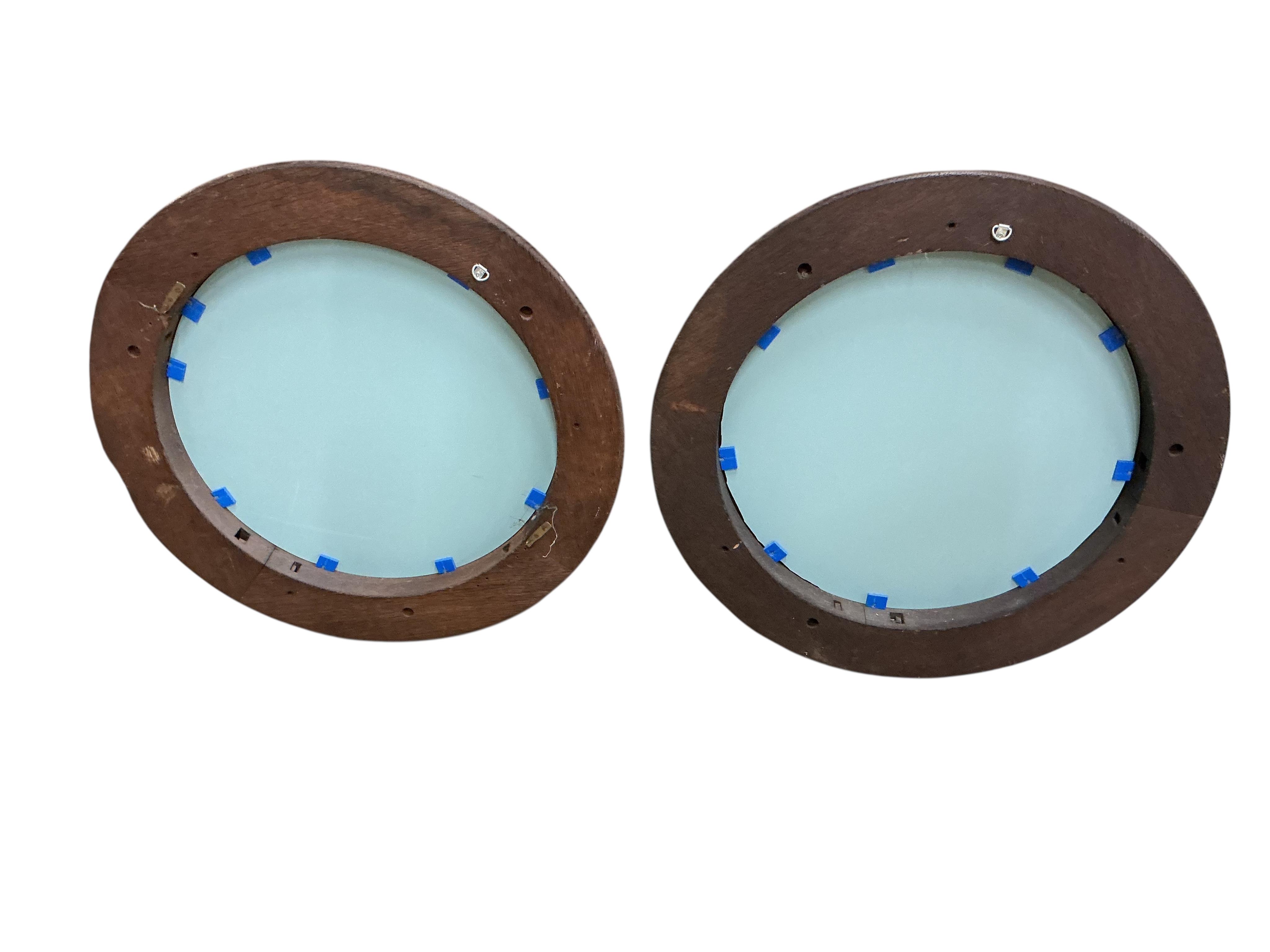 A pair of Victorian circular carved oak wall mirrors, with leaf and acorn borders, diameter 60cm